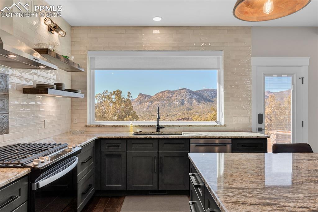 228 Freek Ranch Road Canon City, CO 81212 - Photo 25 of 50 a kitchen with stainless steel appliances granite countertop a stove a sink and a microwave