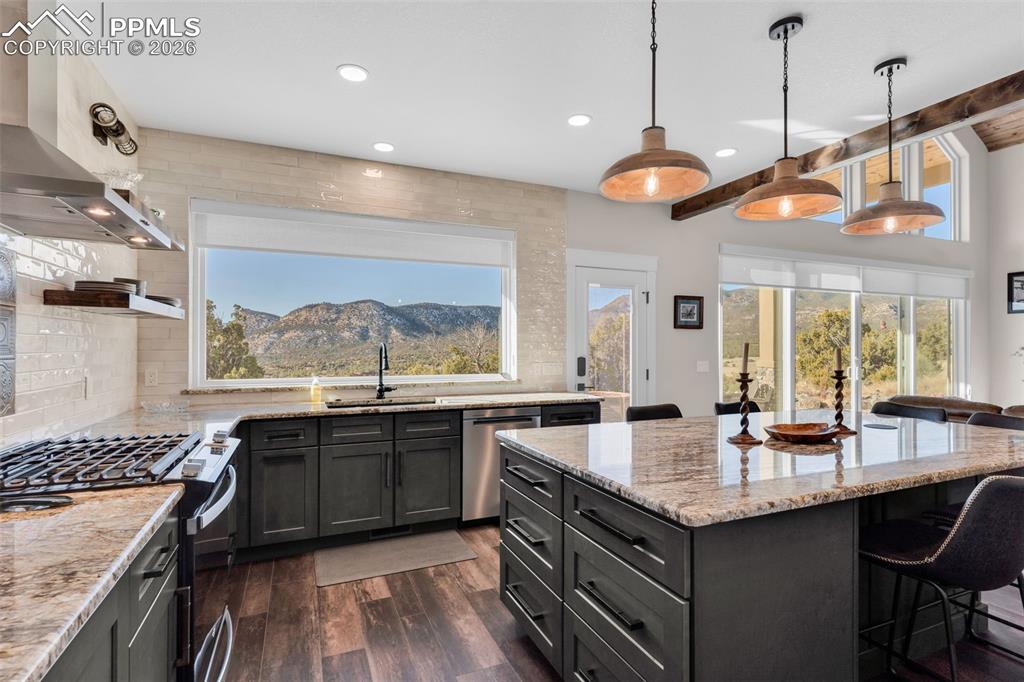 228 Freek Ranch Road Canon City, CO 81212 - Photo 27 of 50 a kitchen with granite countertop a sink and a stove