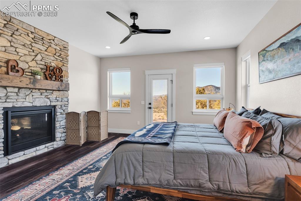 228 Freek Ranch Road Canon City, CO 81212 - Photo 28 of 50 a bedroom with a bed and a fireplace