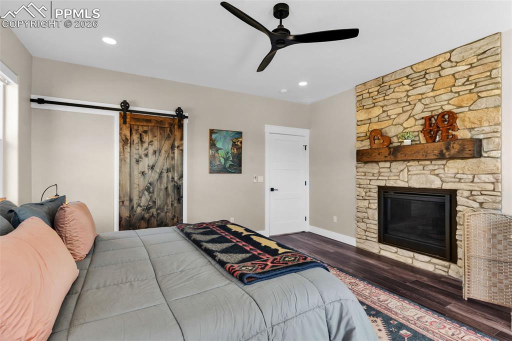 228 Freek Ranch Road Canon City, CO 81212 - Photo 29 of 50 a bedroom with a bed and a fireplace