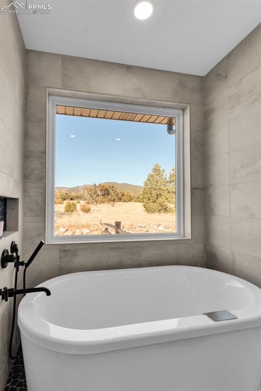 228 Freek Ranch Road Canon City, CO 81212 - Photo 32 of 50 a white bath tub sitting in a bathroom