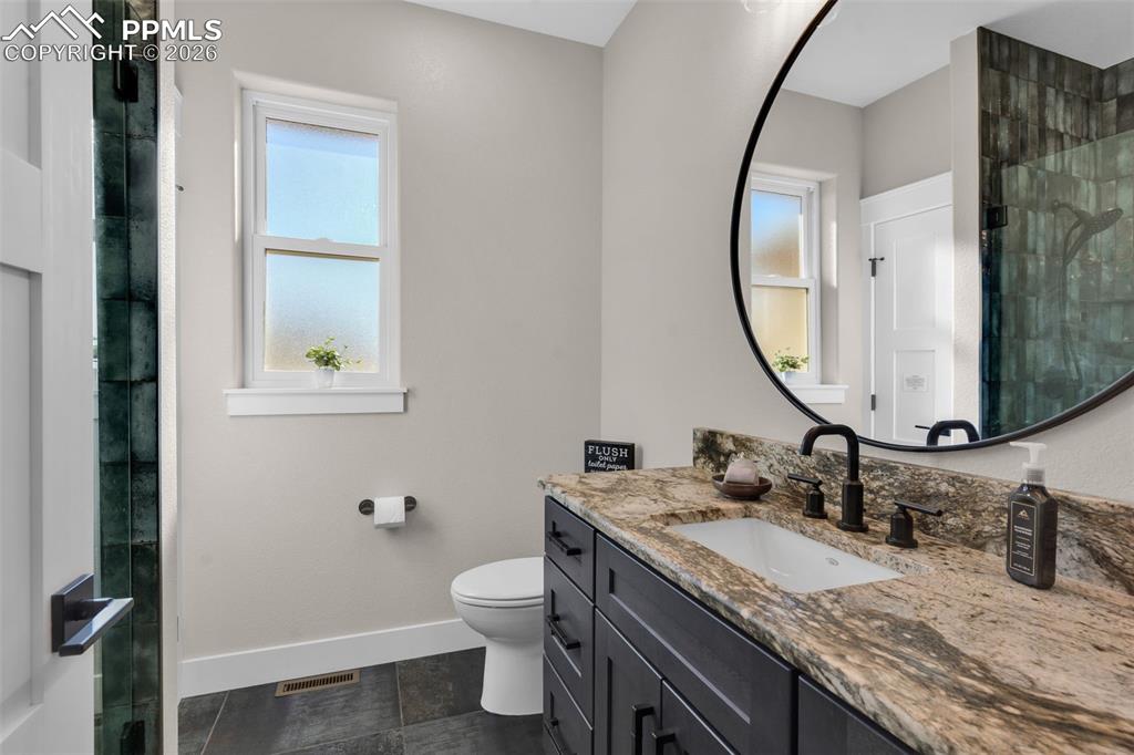 228 Freek Ranch Road Canon City, CO 81212 - Photo 37 of 50 a bathroom with a granite countertop sink mirror and toilet