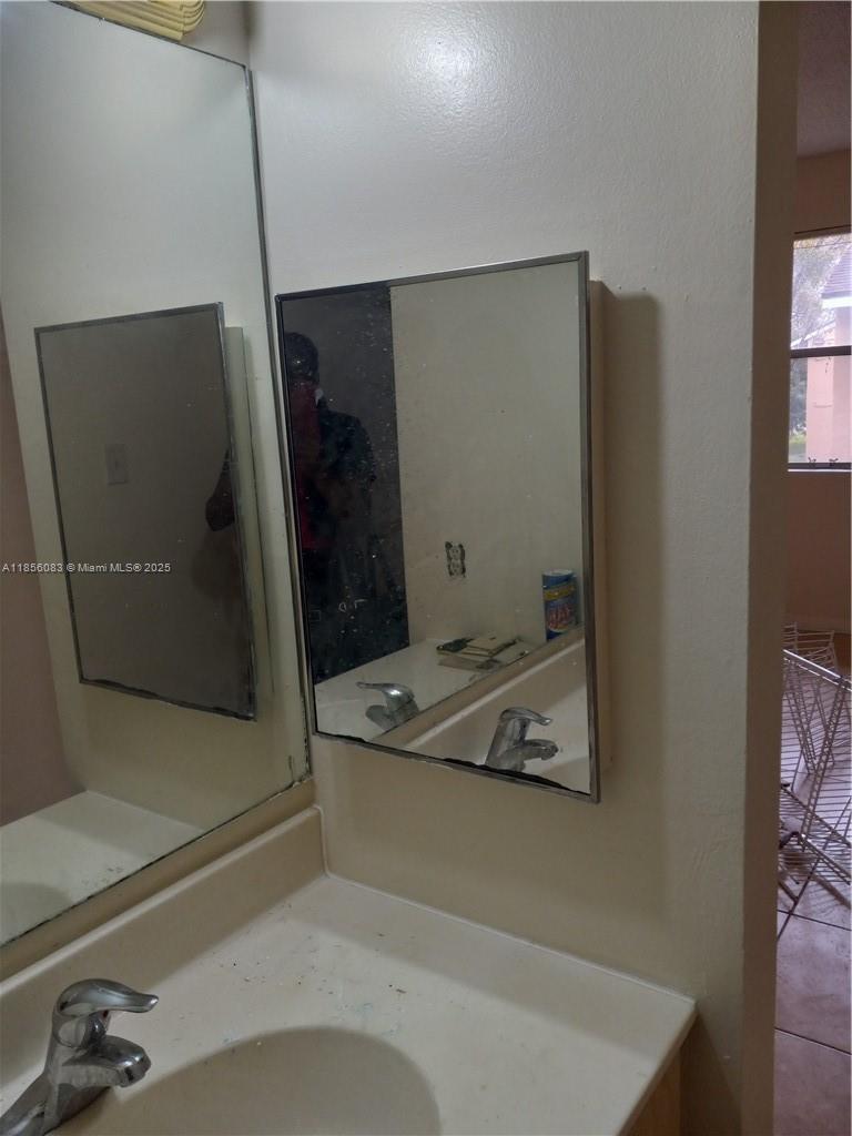 Lakeshore at University Park Miramar, FL 33025 - Photo 12 of 15 a bathroom with a sink a toilet and mirror
