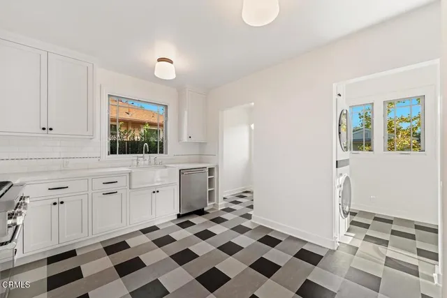 a kitchen with a checkered floor and white cabinets