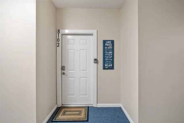 a view of front door with wooden floor