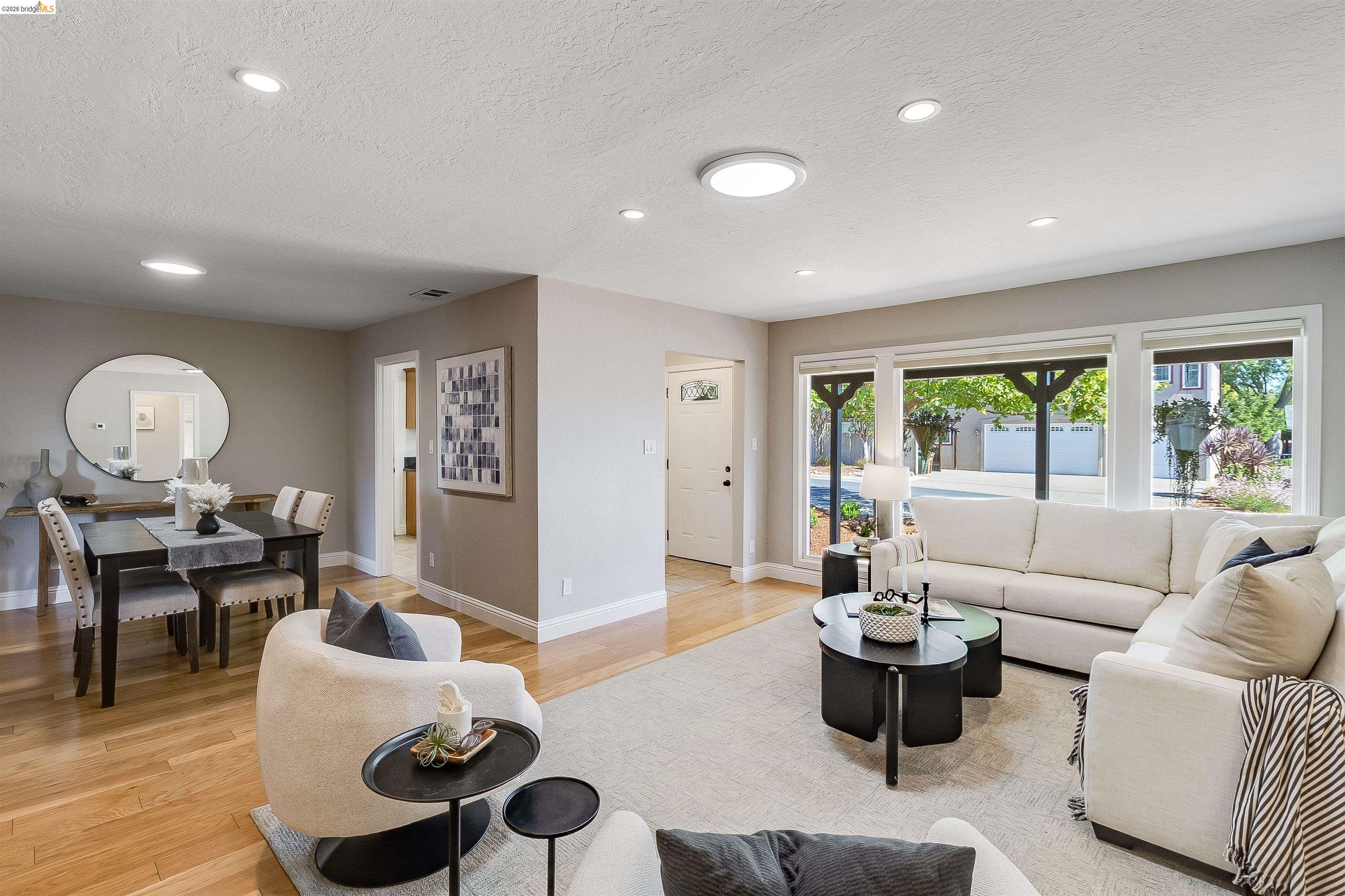 346 Valley View Road Pleasant Hill, CA 94523 - Photo 11 of 57 Open concept living area featuring wood-finish flooring, recessed lighting, and a dining space with a dark wood table