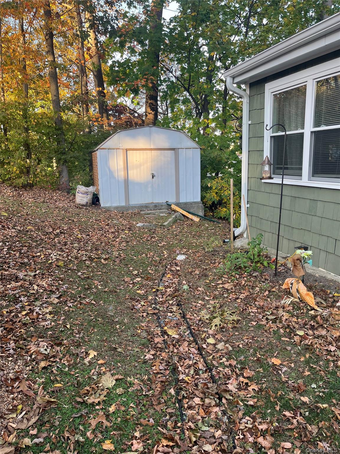 18 Sedgewick Road Carmel, NY 10512 - Photo 2 of 5 a backyard of a house with a yard and garage