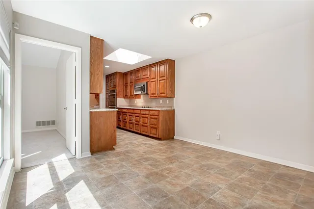 a view of a hallway with a kitchen