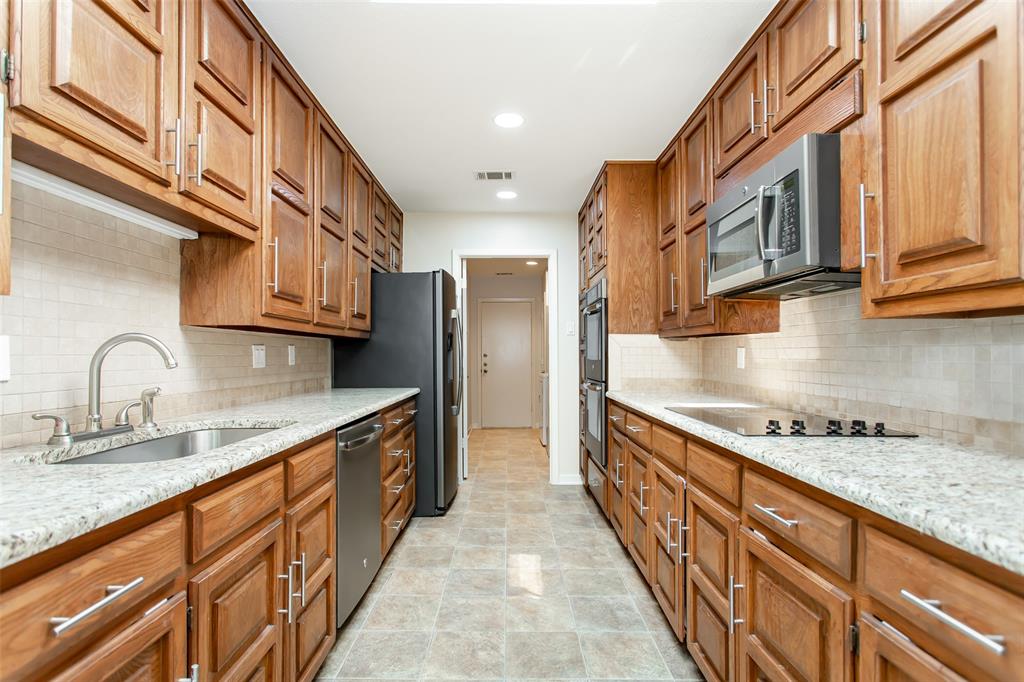 6807 Anglebluff Circle Dallas, TX 75248 - Photo 15 of 28 a large kitchen with stainless steel appliances granite countertop a lot of counter space and a sink