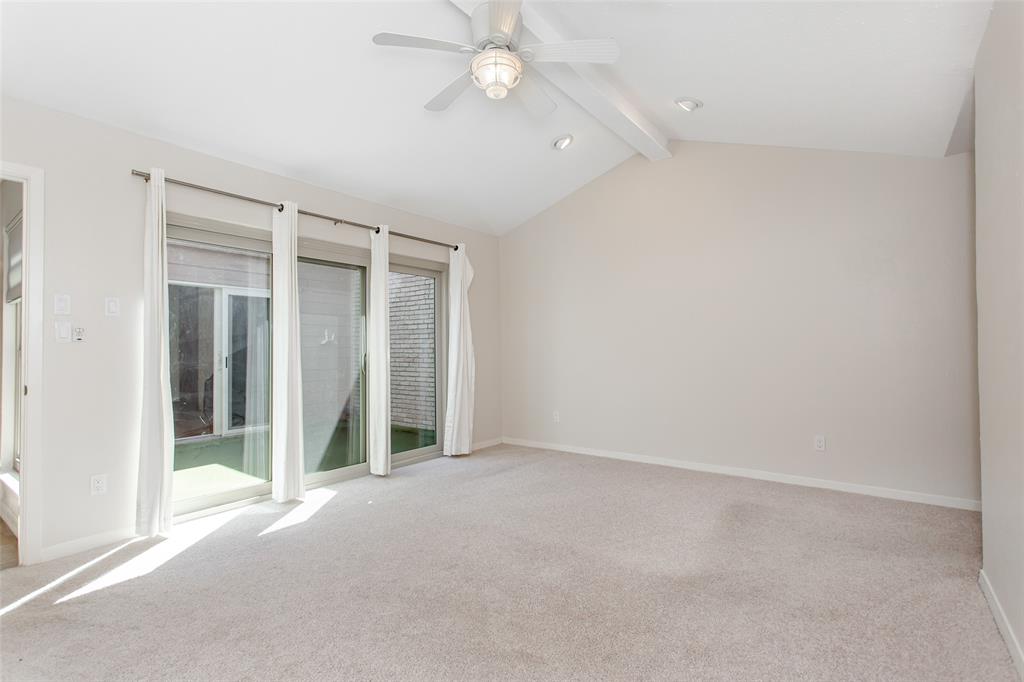 6807 Anglebluff Circle Dallas, TX 75248 - Photo 19 of 28 an empty room with chandelier fan and windows