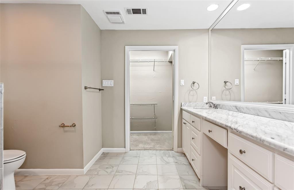 6807 Anglebluff Circle Dallas, TX 75248 - Photo 22 of 28 a bathroom with a granite countertop sink a toilet and shower