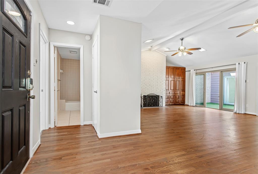 6807 Anglebluff Circle Dallas, TX 75248 - Photo 3 of 28 a view of a hallway with wooden floor and a living room