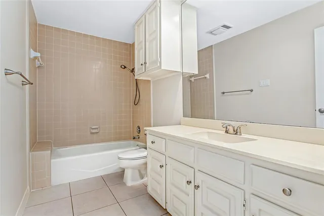 a bathroom with a double vanity sink toilet mirror and bathtub