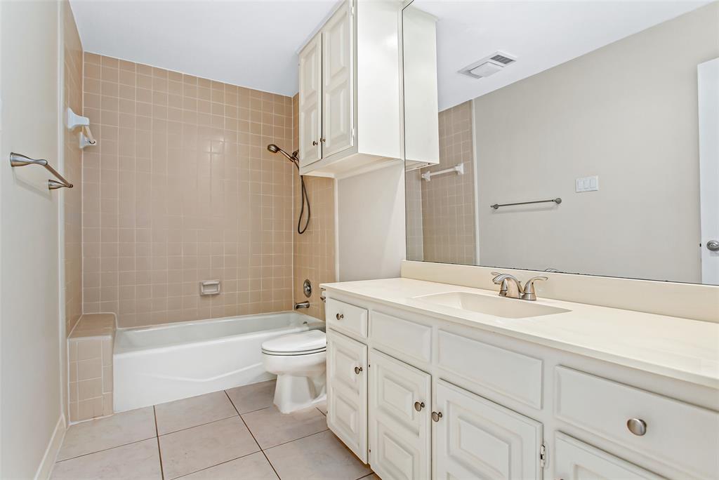 6807 Anglebluff Circle Dallas, TX 75248 - Photo 4 of 28 a bathroom with a double vanity sink toilet mirror and bathtub