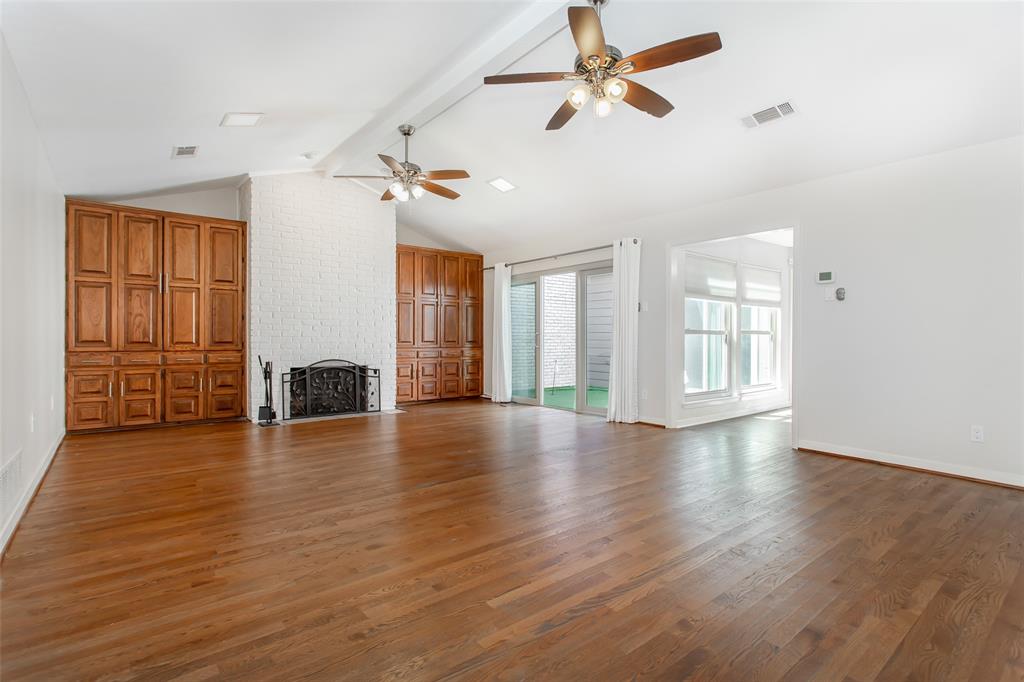 6807 Anglebluff Circle Dallas, TX 75248 - Photo 7 of 28 a view of an empty room with window and wooden floor