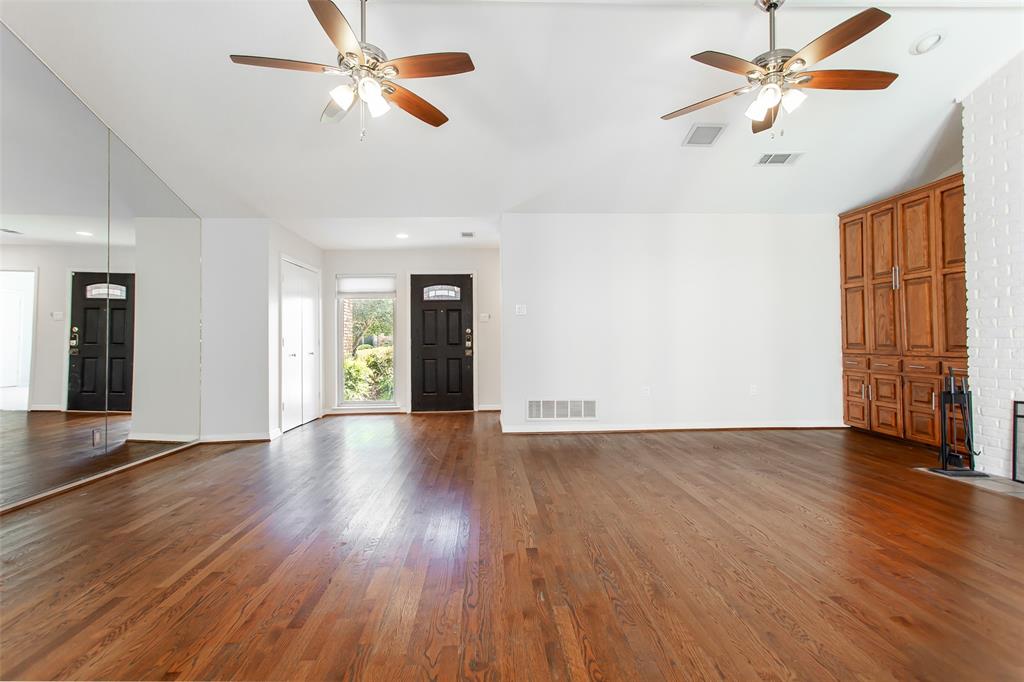 6807 Anglebluff Circle Dallas, TX 75248 - Photo 9 of 28 a view of an empty room with window and wooden floor