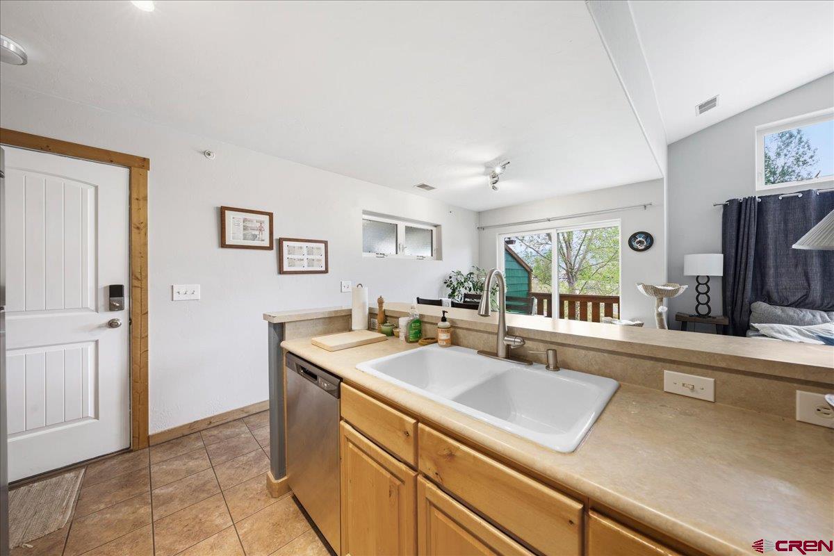 520 Redcliff Circle, Unit G203 Ridgway, CO 81432 - Photo 4 of 25 a open kitchen with stainless steel appliances granite countertop a sink and a refrigerator