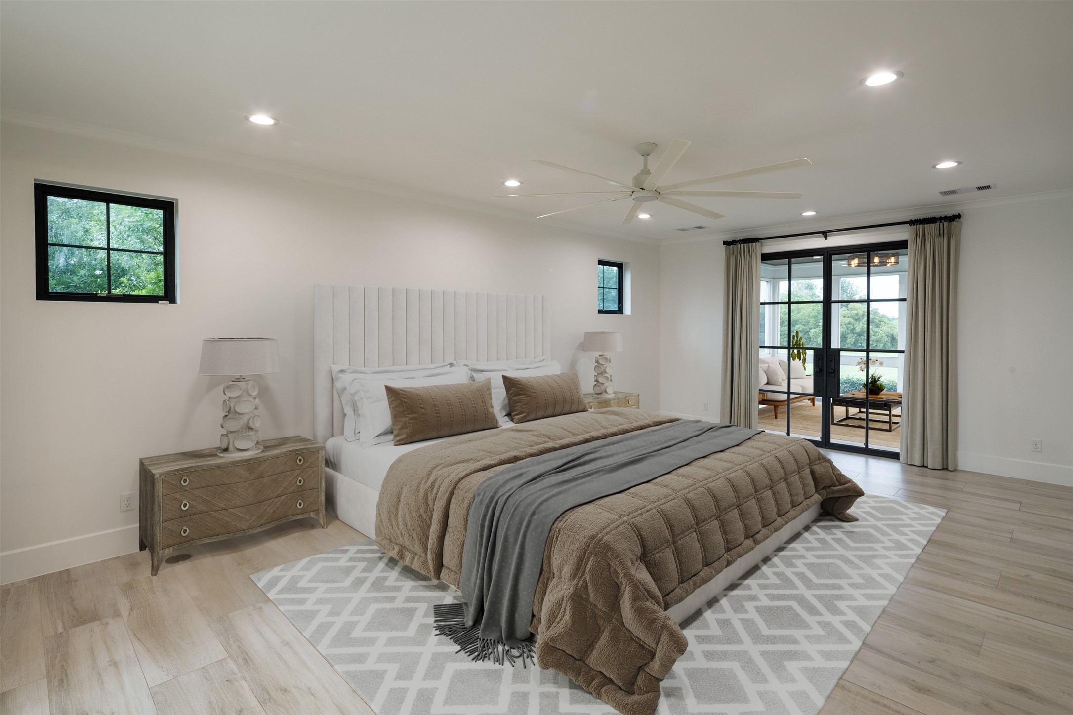24118 Margerstadt Road Hockley, TX 77447 - Photo 23 of 46 Set within a separate wing of the home, the primary bedroom combines direct outdoor access, elevated ceiling heights, and quiet pasture views beyond the windows. The layout creates separation from the main living areas while maintaining the open feel carried throughout the residence.