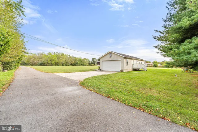 a view of an empty room and wooden floor