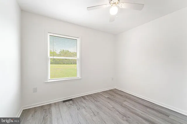 a view of a kitchen with a sink and dishwasher with wooden floor