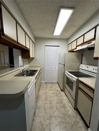 a kitchen with a stove and a refrigerator