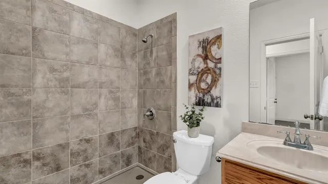a bathroom with a sink toilet and shower
