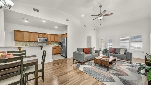a living room with furniture and kitchen view