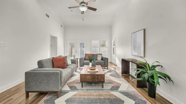 a living room with furniture and a potted plant