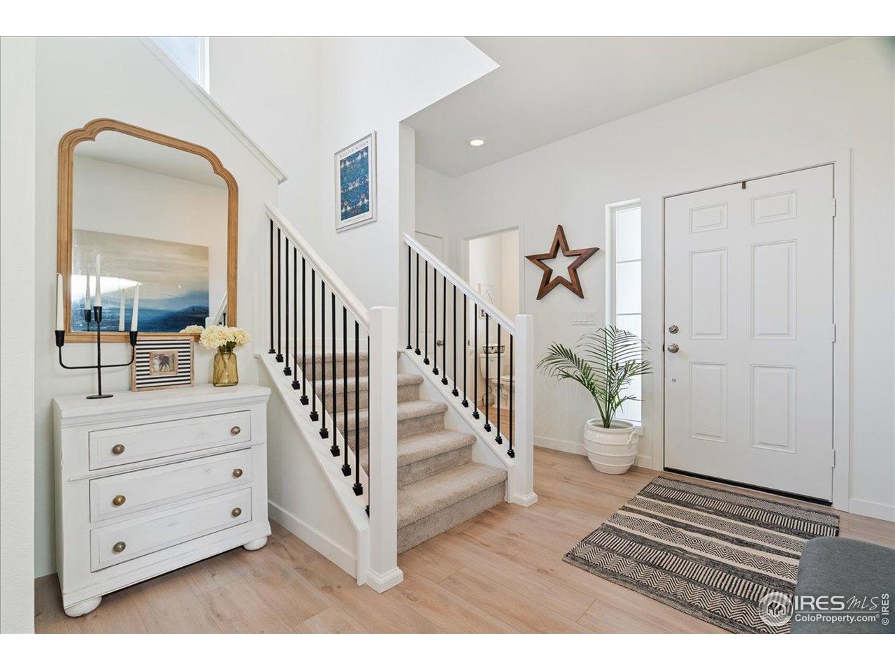 5572 Mare Lane Timnath, CO 80547 - Photo 3 of 36 a view of a hallway to a bedroom and stairs