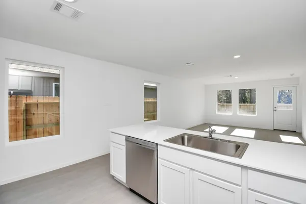 a kitchen that has a sink and a stove