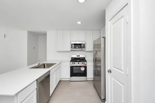 a kitchen with cabinets and stainless steel appliances
