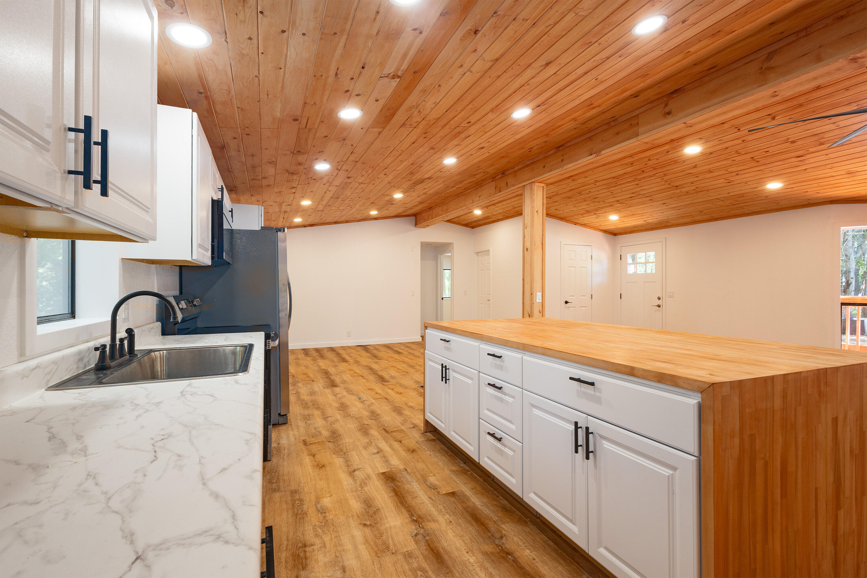 601 Pinewood Way Cave Junction, OR 97523 - Photo 8 of 33 a kitchen with granite countertop white cabinets and sink