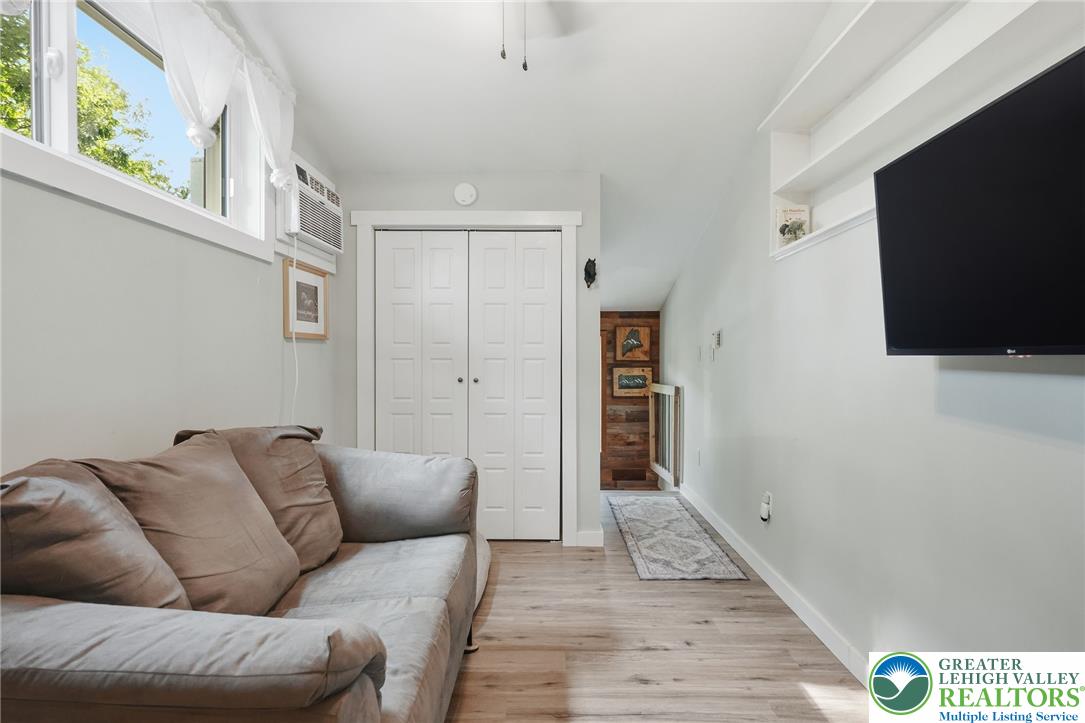 9033 Loop Road Slatington, PA 18080 - Photo 31 of 53 Laminate flooring extends into a cozy living space with bright windows and a convenient closet.