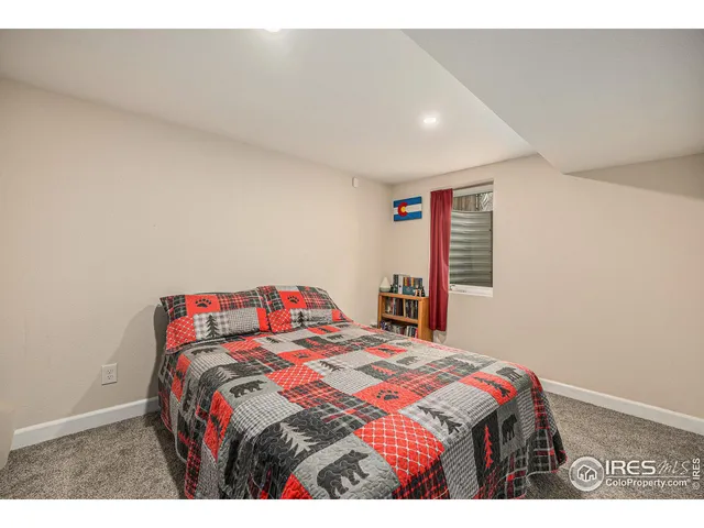 a bedroom with a bed and a book shelf