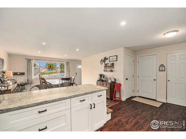 a view living room with granite countertop a couch and a large mirror on the dresser