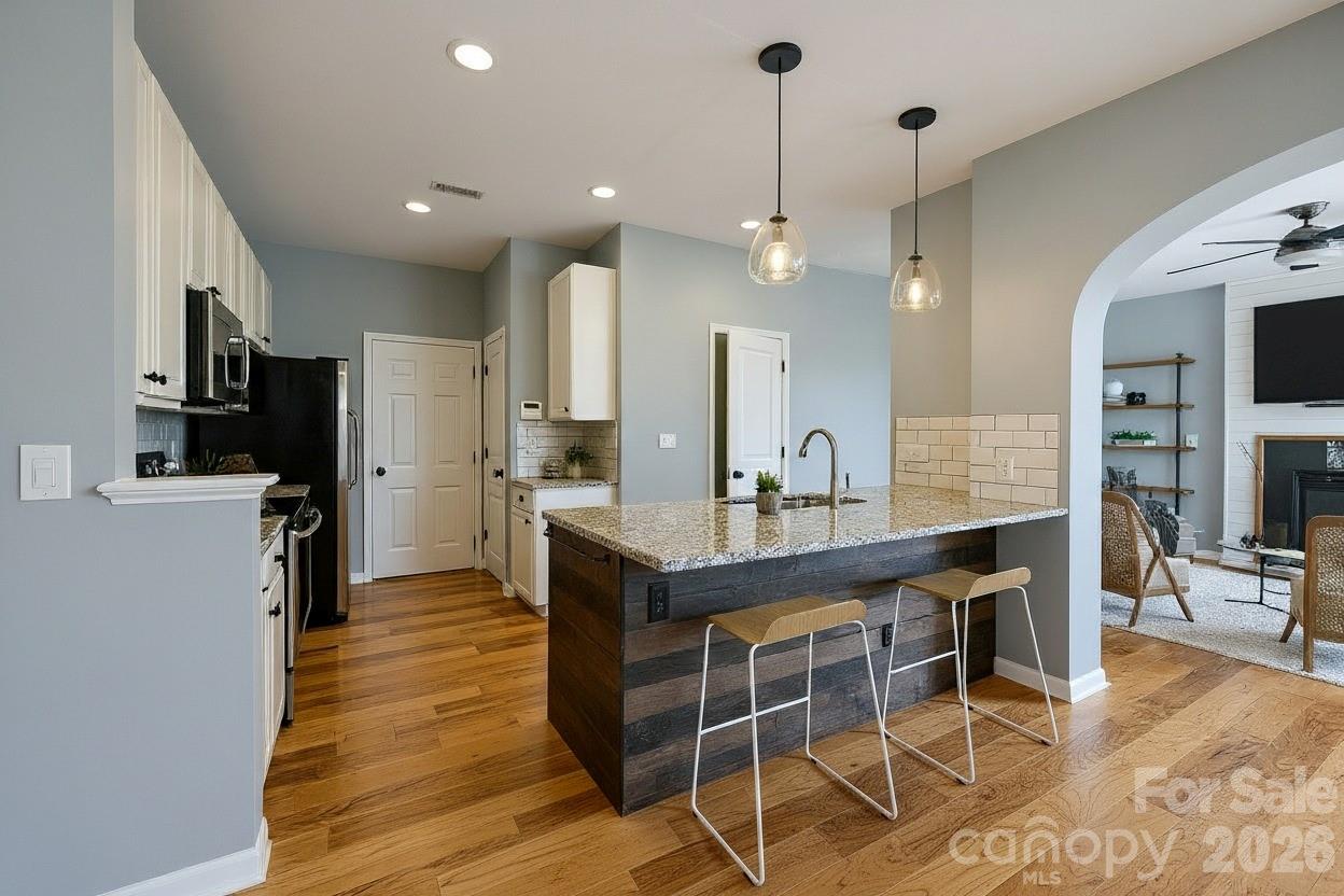 3110 Tanzanite Circle Fort Mill, SC 29708 - Photo 18 of 48 a kitchen with granite countertop a counter space dining table stainless steel appliances and cabinets