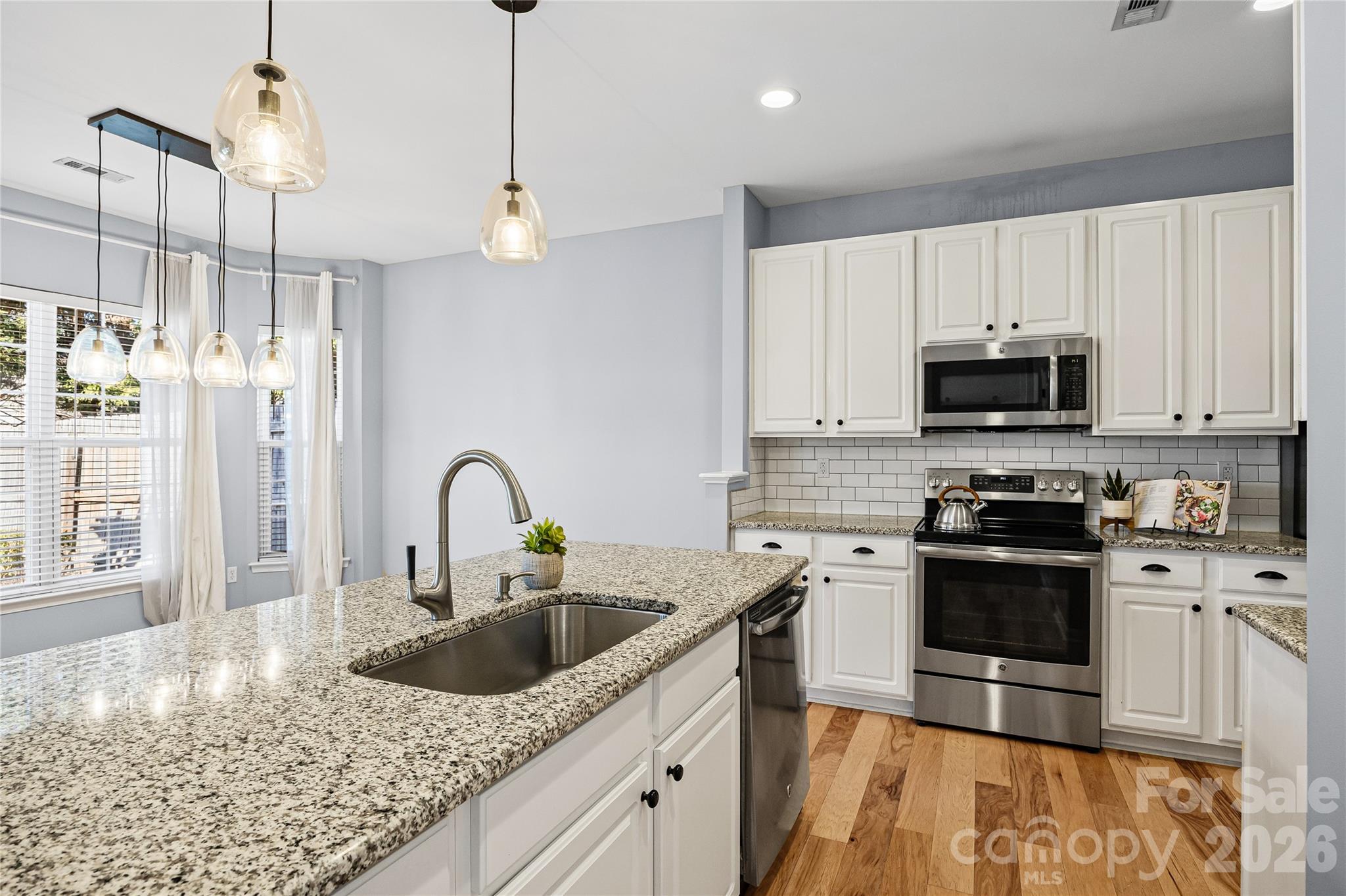 3110 Tanzanite Circle Fort Mill, SC 29708 - Photo 21 of 48 a kitchen with stainless steel appliances granite countertop a sink a stove top oven a counter space and cabinets