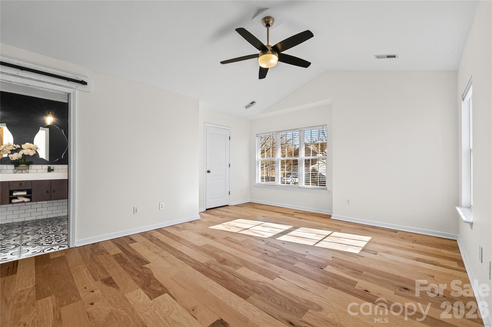 3110 Tanzanite Circle Fort Mill, SC 29708 - Photo 30 of 48 an empty room with wooden floor and windows