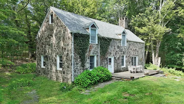a view of a house with sitting area and garden
