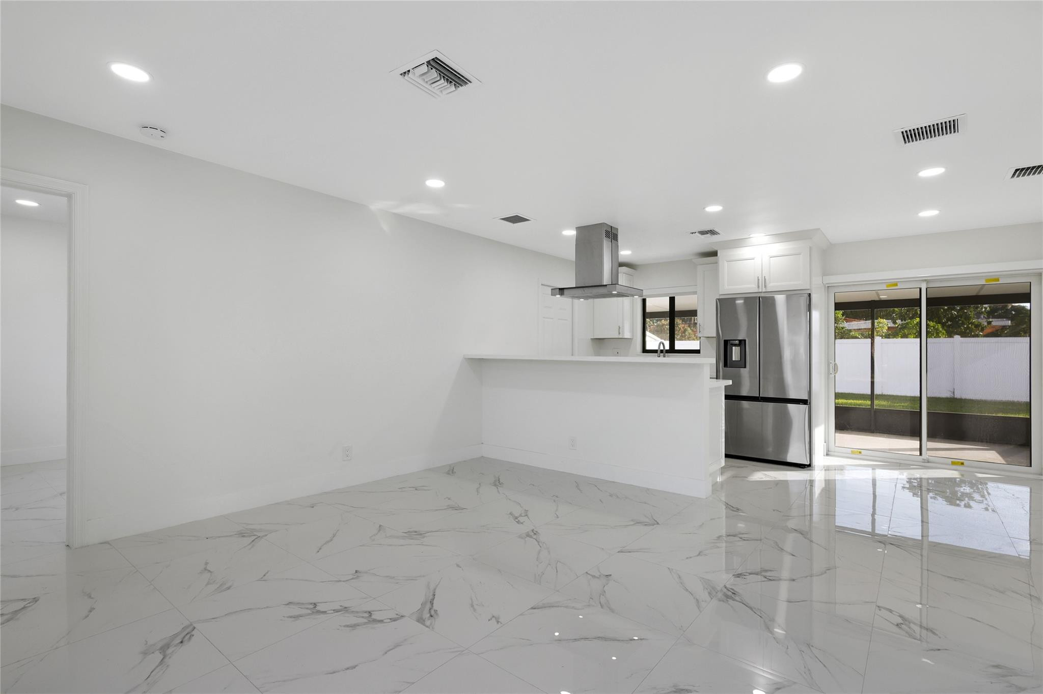 6374 Southwest 2nd Street Margate, FL 33068 - Photo 14 of 28 a view of a kitchen with refrigerator and an empty room