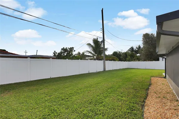 a view of a house with a yard and sitting area