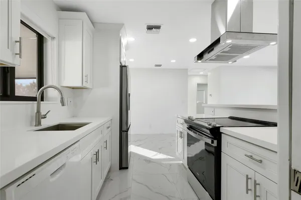 a kitchen with a stove and a sink