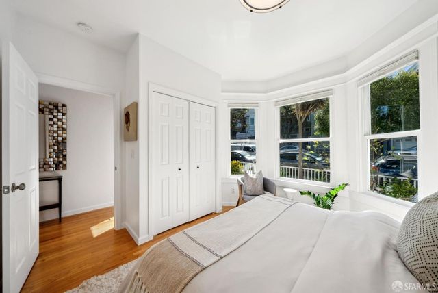 a bedroom with a bed and a mirror