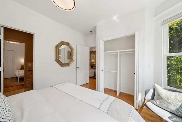 a bed room with a bed and a chair