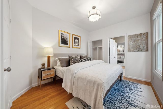 a bedroom with bed and a window