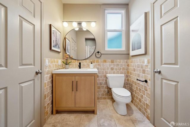 a bathroom with a sink a toilet and a mirror