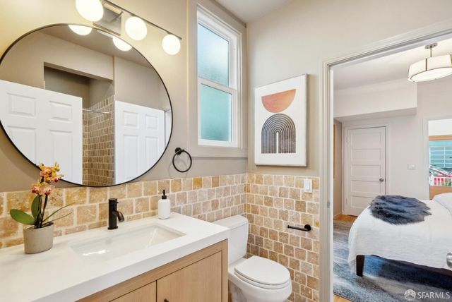 a bathroom with a toilet sink and mirror