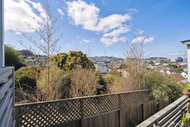 a balcony with furniture and a large window