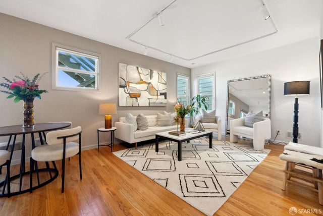 a view of a dining room with furniture and a potted plant