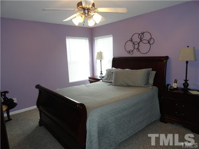4705 Alenja Lane Raleigh, NC 27616 - Photo 11 of 15 a bedroom with a bed and a chandelier